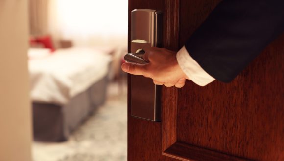 Picture showing hand of businessman opening hotel room